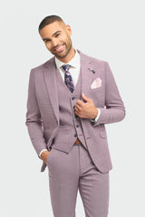 Man wearing a light purple suit with a white shirt and patterned tie on a light gray background
